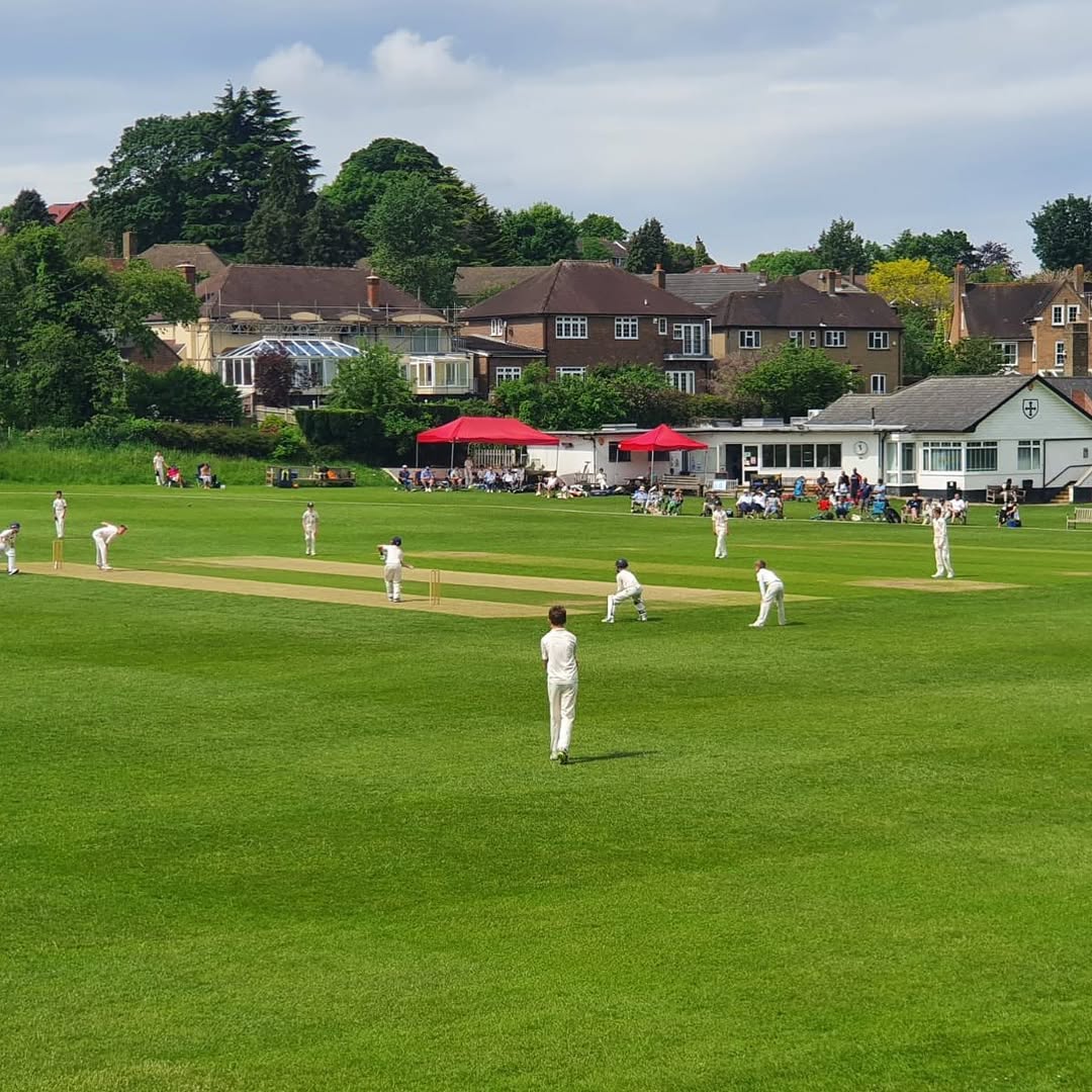 ricket match in progress on lush green fields at Old Whits Clubhouse in South Croydon